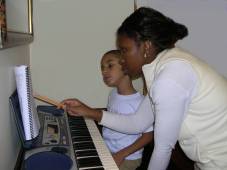 mom helps at the piano